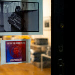 Photos on the window of a art gallery inside George Floyd Square.