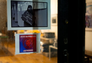 Photos on the window of a art gallery inside George Floyd Square.