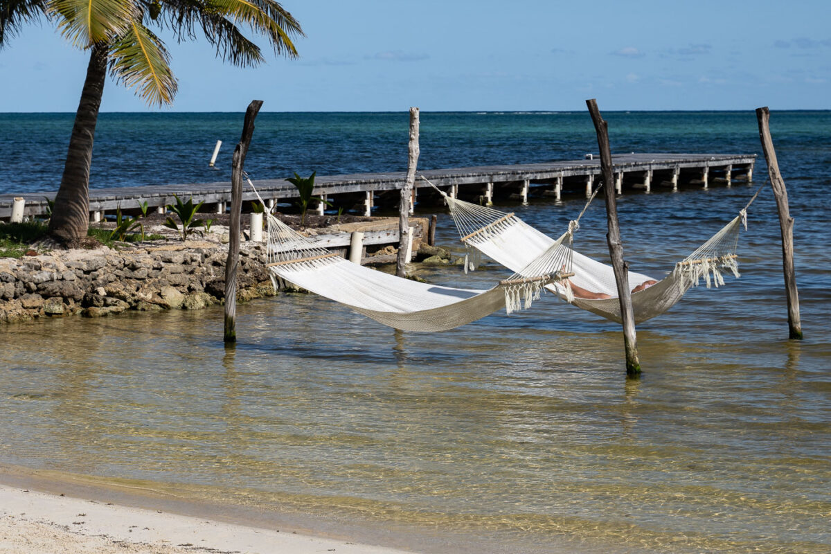 A man sits in a hammock on  Ambergris Caye, Belize.