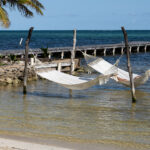 A man sits in a hammock on  Ambergris Caye, Belize.