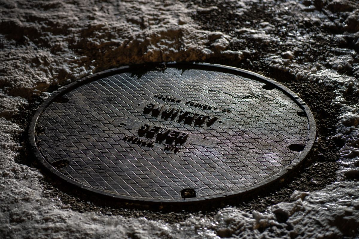Neenah Foundry sanitary sewer manhole cover in Minneapolis snow.