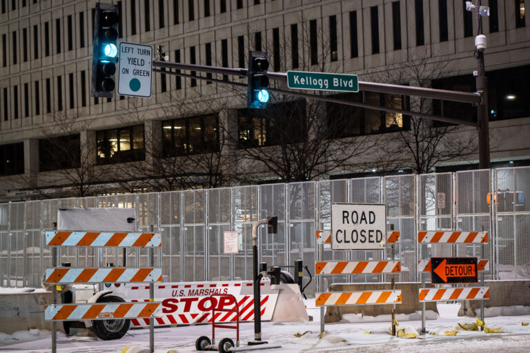 Road Closed US Marshal STOP barricades 1 Security around the Warren E. Burger Federal Building in downtown St. Paul the night before opening statements in the trial of the officers accused of violating George Floyd's civil rights.