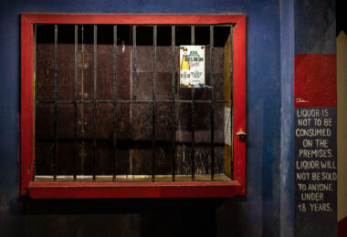 A closed storefront in San Pedro, Belize. Written on the wall is “Liquor is not to be consumed on the premises. Liqour will not be sold to anyone under 18 years."