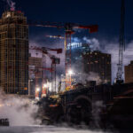 Tower cranes and steam from the Mississippi River on a night where temperatures hit -15F.