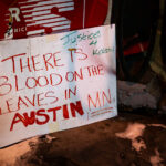 A sign at George Floyd Square mentioning Kokou Christopher Fiafonou. Fiafonou was shot and killed by law enforcement in Austin, Minnesota on December 23, 2021. Authorities said shortly after that Fiafonou was armed with a knife and was threatening others.