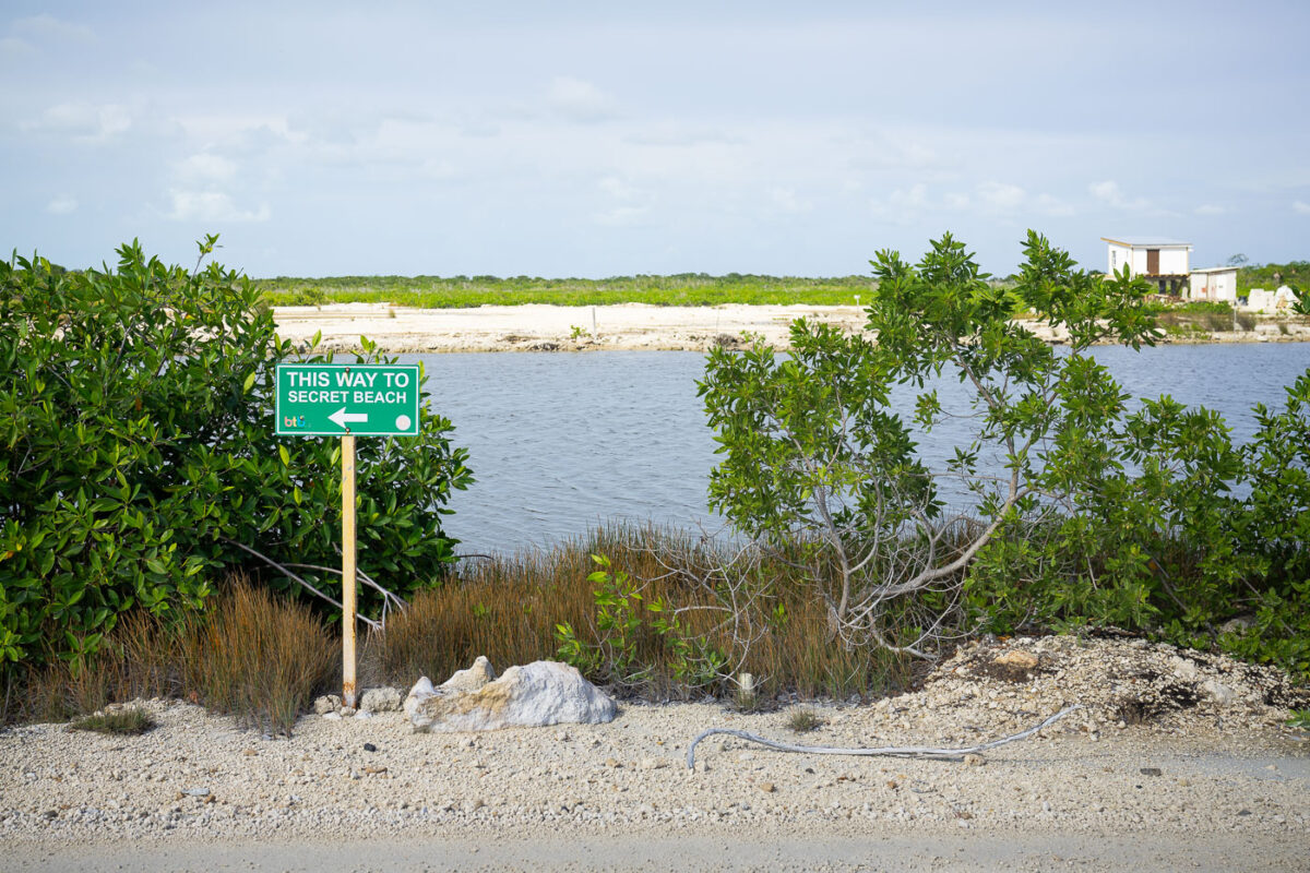 A sign pointing to Secret Beach in San Pedro, Belize.