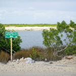 A sign pointing to Secret Beach in San Pedro, Belize.
