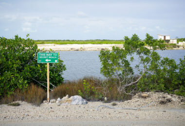 A sign pointing to Secret Beach in San Pedro, Belize.