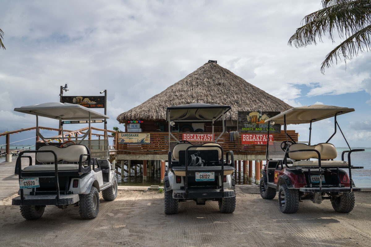 Golf carts parked outside Ugly Duck Sports Bar & Grill in San Pedro on Ambergris Caye in Belize.