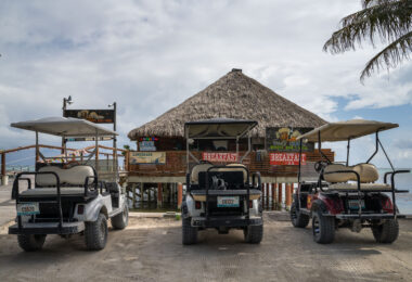 Golf carts parked outside Ugly Duck Sports Bar & Grill in San Pedro on Ambergris Caye in Belize.