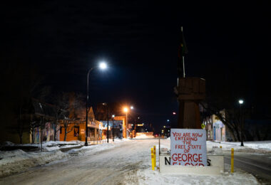 The fist at the intersection of 37th and Chicago in South Minneapolis. A sign that reads “You are now entering the free state of George Floyd”.