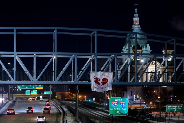 Minneapolis: Banner on I-94 Bridge Protests Mayor Frey 3 A banner protesting Minneapolis Mayor Jacob Frey hangs from a pedestrian bridge over Interstate 94 on Valentine's Day. The banner reads "DONE WITH YOUR LIES" and "#BreakUpWithJacob," featuring a broken heart symbol and "MPLS" and "FREY." The protest took place near the Lowry Hill Tunnel, a significant piece of urban infrastructure that facilitates traffic flow through the city. The presence of the banner on this date amplifies its message of discontent with the mayor's policies or actions.