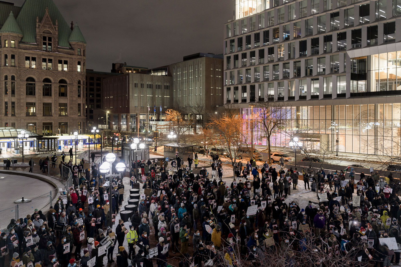 A protest for Amir Locke took place at Government Plaza in Downtown Minneapolis following his death by police. Protesters gathered in the public space, surrounded by modern office buildings and historic architecture, to demand accountability after Locke was killed during a no-knock warrant execution. The event highlights the ongoing public discourse and activism surrounding police conduct and accountability in urban environments.