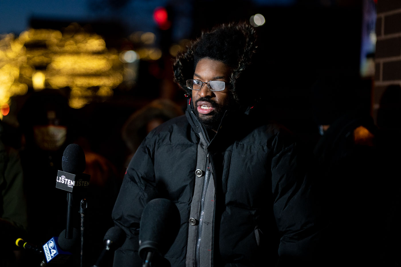 Activist DJ Hooker speaks at a protest in Minneapolis on a cold night following the police shooting death of Amir Locke. The protest occurred shortly after Locke was killed by officers executing a no-knock warrant. Activists demanded the prompt release of information regarding the incident, which was under investigation by the Bureau of Criminal Apprehension.