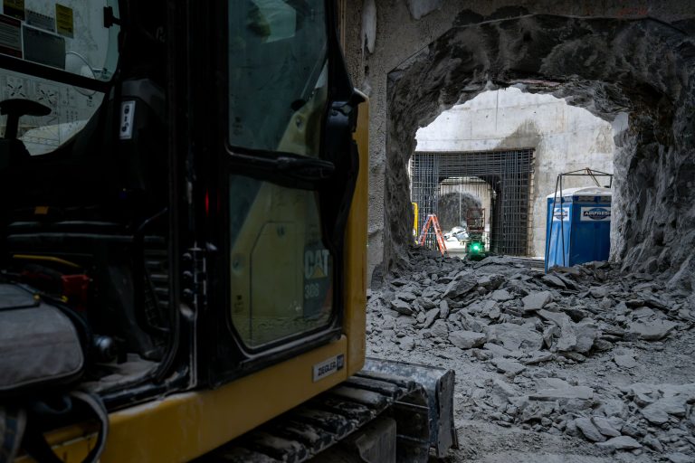 Excavation at I-35W Stormwater Storage Facility, Minneapolis 2 Yellow excavator operates inside underground tunnel of MnDOT I-35W stormwater storage facility under construction.