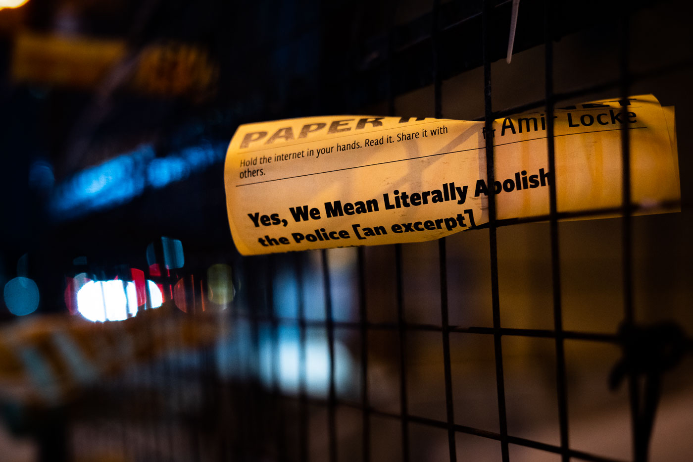 Flyers advocating for police abolition, including an excerpt from Mariame Kaba's New York Times opinion piece, were posted on fencing around the Minneapolis Police 3rd Precinct. The flyers also reference Amir Locke, who was killed by Minneapolis police in February 2022. This display reflects the ongoing protests and discourse surrounding policing in Minneapolis, particularly following the Minneapolis Uprising and the deaths of George Floyd and Amir Locke.