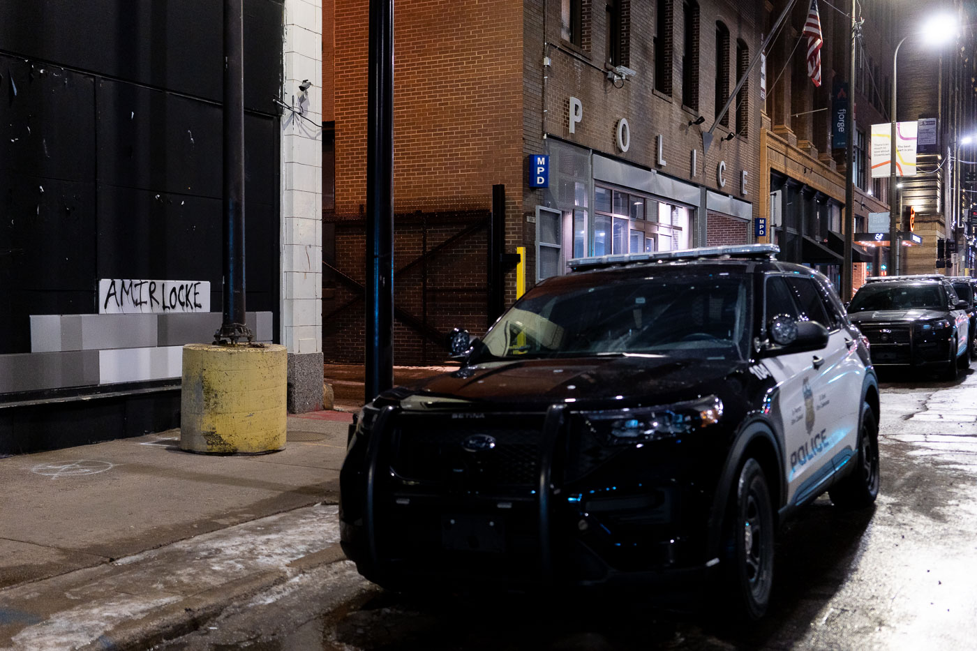 Graffiti honoring Amir Locke is displayed on the exterior of the Minneapolis Police Department's First Precinct building in downtown Minneapolis. Locke, a 22-year-old Black man, was killed by a Minneapolis police officer during a no-knock warrant execution in February 2022. His death led to protests and renewed calls for police reform in the city. The First Precinct building has served as a site for public expression following incidents of police violence, with this graffiti acting as a memorial and a statement of remembrance for Locke and the broader movement for racial justice.