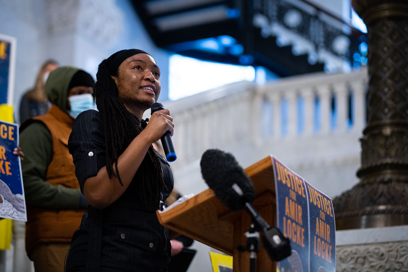 Jeanelle Austin speaks at a protest outside Minneapolis City Hall on February 2, 2022, following the police shooting death of Amir Locke. Attendees gathered to advocate for justice and deliver ethics complaints against Mayor Jacob Frey, citing concerns over his handling of the incident and police conduct. Minneapolis City Hall, a Beaux-Arts building completed in 1909, serves as the seat of government for the city, housing administrative offices and council chambers. It has historically been a site for public discourse and civic action, reflecting its role as a center for democratic processes.