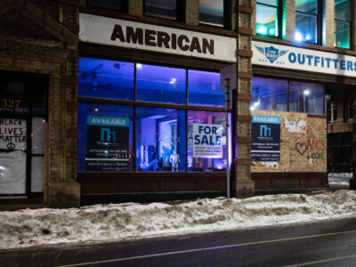 Minneapolis: American Outfitters boarded, "For Sale" sign, Amir Locke graffiti