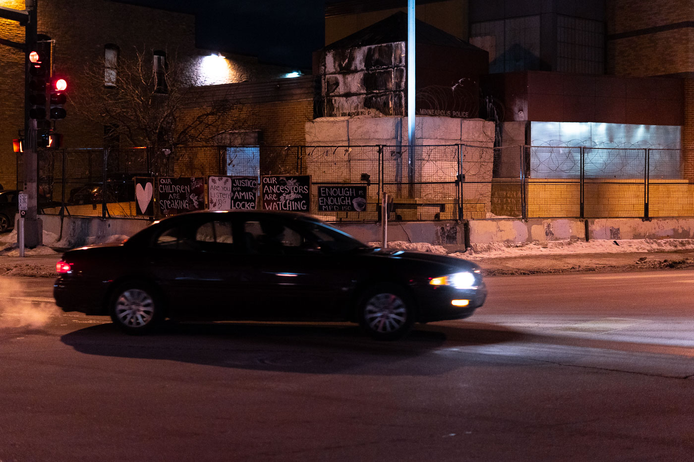 Protests against police brutality continued for ten days following the fatal shooting of Amir Locke by Minneapolis Police on February 2, 2022. Signs displayed outside the Minneapolis Police 3rd Precinct read "Our Children Are Speaking," "Justice for Amir Locke," and "Our Ancestors Are Watching." The protests, which occurred in the Uptown area of Minneapolis, involved chants and graffiti, reflecting ongoing public outcry against police conduct.