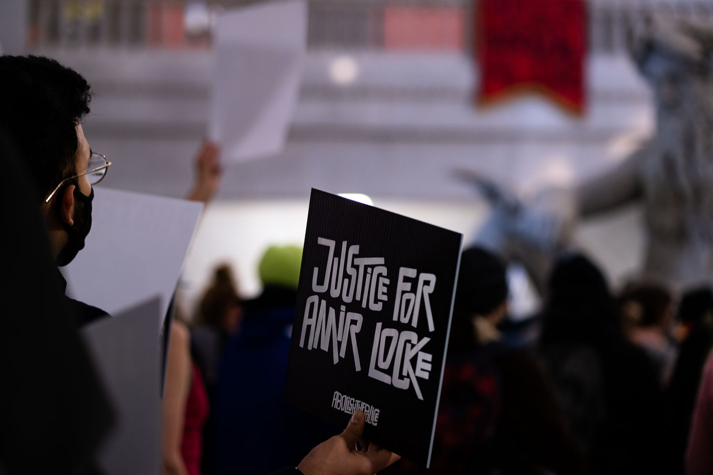 Minneapolis residents gathered at City Hall on February 4, 2022, to protest the police shooting death of Amir Locke. Demonstrators delivered ethics complaints against Mayor Jacob Frey to the city attorney's office, citing the incident. The "Justice for Amir Locke" sign held by a protester reflects the ongoing calls for accountability and justice following the event. Minneapolis City Hall, completed in 1909, serves as the seat of government for the city and houses its administrative offices and council chambers.