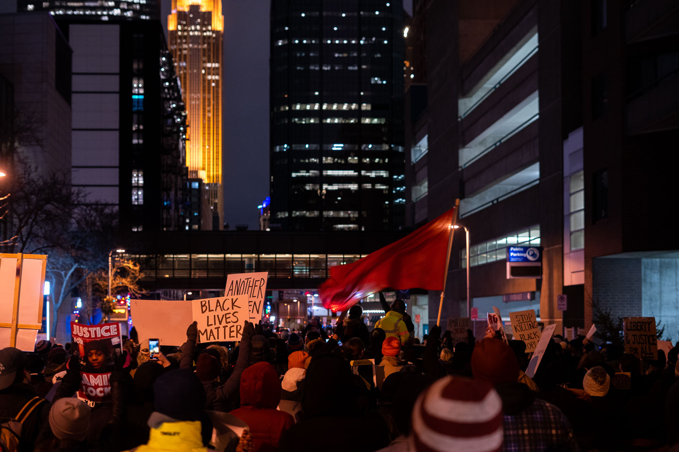 Protesters gathered in Downtown Minneapolis to demand accountability following the police shooting death of Amir Locke. Locke was killed by Minneapolis police officers executing a no-knock warrant in February 2022. The protest, which occurred shortly after the incident, highlighted ongoing concerns about police conduct and racial justice in the city. The march took place amidst the urban environment of Minneapolis, with participants carrying signs and voicing their demands for systemic change.