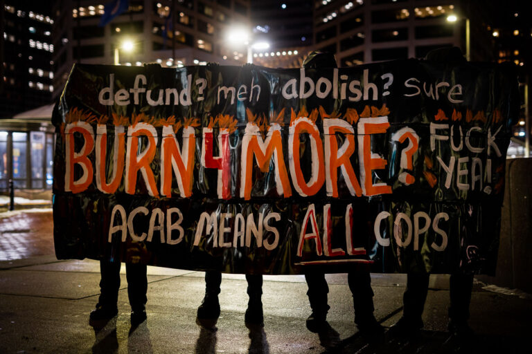 Minneapolis Protest: "Burn 4 More" and "ACAB" Banner 3 Protesters marched through Downtown Minneapolis following the police killing of Amir Locke on February 2, 2022. The banner, held by participants, reads "defund? meh abolish? sure BURN4MORE? FUCK YEAH! ACAB MEANS ALL COPS." The phrase "ACAB" is a common protest slogan meaning "All Cops Are Bastards." This march occurred in the aftermath of Locke's death during a no-knock warrant execution by Minneapolis Police.