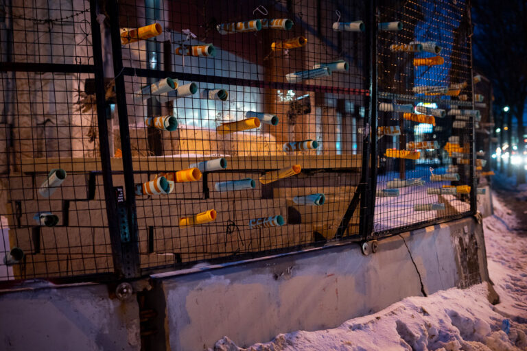 Minneapolis Police 3rd Precinct Barricade with "Abolish The Police" Flyers 1 The former Minneapolis Police Third Precinct, damaged during protests in May 2020, is shown barricaded and adorned with flyers. These materials, including an opinion piece by Mariame Kaba titled "Yes, We Mean Literally Abolish The Police," originally published in The New York Times on June 12, 2020, signify the ongoing public discourse and protest following the precinct's destruction. The presence of these flyers on the barricade of the damaged building serves as a visual marker of the events and sentiments that transpired in Minneapolis.