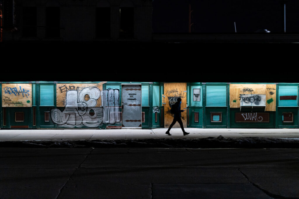 A man walks past a closed bar in South Minneapolis.