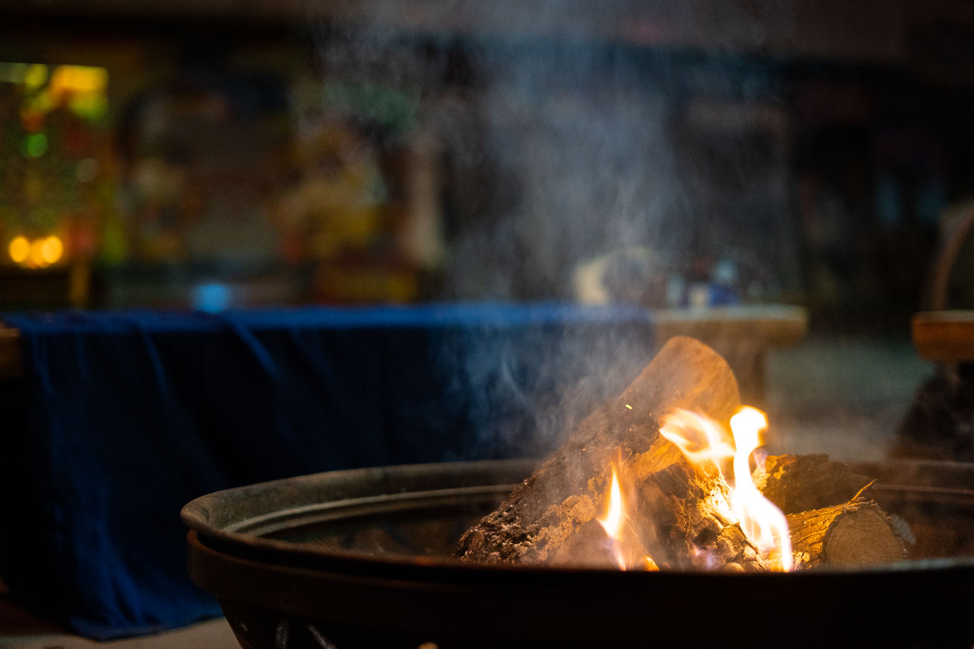 A fire pit burns at George Floyd Square, also known as "The People's Way," in Minneapolis. This location became a significant site for protests and community organizing following the murder of George Floyd in May 2020. The fire pit serves as a gathering point and a symbol of resilience and community presence within the area. It represents a space for warmth, reflection, and ongoing dialogue among those who frequent the square.