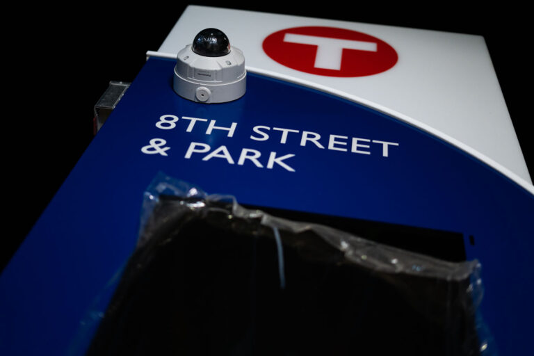 Minneapolis Bus Stop Signage: 8th St & Park Ave with Security Camera 2 This photograph shows a Metro Transit bus stop sign at the intersection of 8th Street and Park Avenue in Minneapolis. The sign, featuring the Metro Transit logo, indicates a stop for public transportation services. A security camera is mounted on the sign, suggesting a focus on passenger safety and monitoring within the transit system. This infrastructure is integral to the daily operations of Minneapolis's public transit network, serving commuters and visitors.