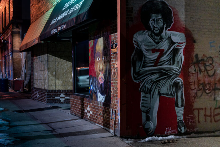 Colin Kaepernick Mural at 812 E 38th St, Minneapolis 5 A mural depicting former NFL quarterback Colin Kaepernick kneeling is displayed on the exterior of a building at 812 East 38th Street in Minneapolis. The artwork is situated near George Floyd Square, a location that became a significant site of protest and activism following the murder of George Floyd in May 2020. Kaepernick, known for his protests against racial injustice and police brutality during NFL games, is honored in this mural, which serves as a visual statement within a neighborhood that has been central to discussions on racial equality and social justice.