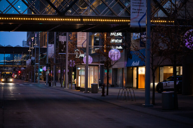 Nicollet Mall, Downtown Minneapolis at Dusk with Police Car 2 Nicollet Mall in downtown Minneapolis is a pedestrian-oriented street designed to foster commerce and public gathering. Originally conceived in the 1960s, it was transformed into a pedestrian mall in 1967, becoming a central hub for shopping, dining, and cultural events. The presence of a Minneapolis Police vehicle suggests ongoing public safety presence, which is a common sight in urban centers, particularly in areas that have experienced significant events such as the Minneapolis Uprising.
