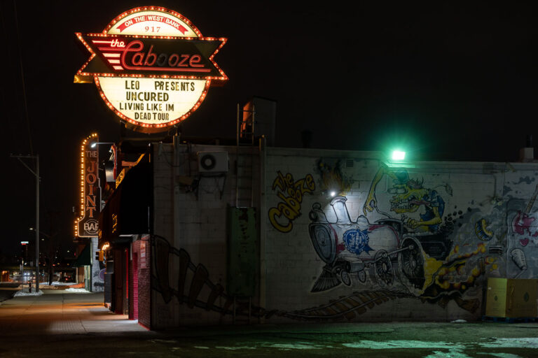 The Cabooze Minneapolis: Leo Presents Uncured, Living Like Im Dead Tour 2 The Cabooze, a long-standing live music venue on Minneapolis's West Bank, is illuminated at night. The venue's marquee advertises a performance by Leo Presents featuring the bands Uncured and Living Like I'm Dead Tour. Established in 1969, The Cabooze has been a significant venue in the Minneapolis music scene, hosting a diverse array of local and national artists. The building's exterior features vibrant graffiti art, including a mural depicting a train engine, reflecting the venue's distinctive character and its role in the city's cultural fabric.
