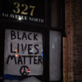 A "Black Lives Matter" sign covering a window in downtown Minneapolis.