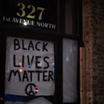 A "Black Lives Matter" sign covering a window in downtown Minneapolis.