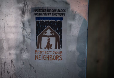 A flyer seen on a street sign that reads "Together we can block encampment evictions" "Protest your neighbors".