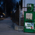 A news rack in South Minneapolis. Star Tribune headline "They must pick: Cop or doctor?"
