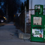 A news rack in South Minneapolis. Star Tribune headline "They must pick: Cop or doctor?"