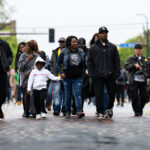 Steve Floyd with Agape Movement walks down Chicago Avenue during the 2nd anniversary of the murder of George Floyd.
