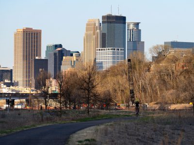 Cedar Lake Trail Biker with Minneapolis Skyline, May 2022