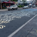 The names of those who've been killed by police being repainted on Chicago Avenue.