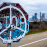 Weak Mayor, Stop Line 3, Detention Centers are for burning stickers on a stop sign in Minneapolis.