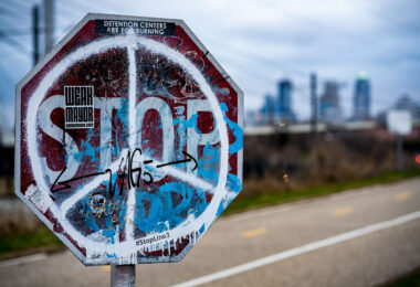 Weak Mayor, Stop Line 3, Detention Centers are for burning stickers on a stop sign in Minneapolis.