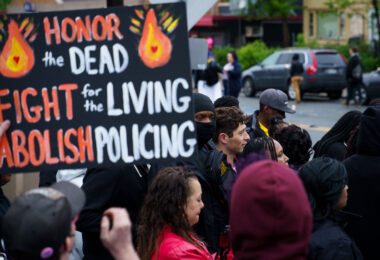 Mayor Jacob Frey and members of The Agape Movement at George Floyd Square in May 2022.