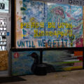 A mural on boards covering the windows at the Loon Smoke Shop on Lyndale Ave in Minneapolis.