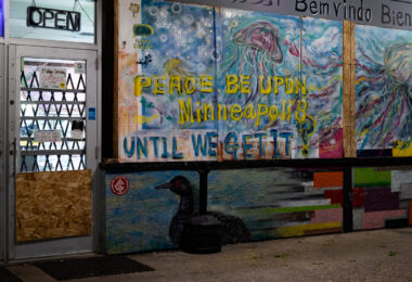 A mural on boards covering the windows at the Loon Smoke Shop on Lyndale Ave in Minneapolis.