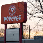 A Popeyes Louisiana Kitchen sign on Chicago Avenue in Minneapolis. The building was destroyed during the Minneapolis Uprising.