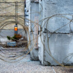 Razor wire around the concrete blocks at the burned Minneapolis 3rd Precinct police station.