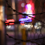 Razor wire on fencing around a parking ramp at Lake Street and Girard Ave in Uptown Minneapolis. The area was home to protests following the shooting death of Winston Smith at the top of the ramp by a federal task force.